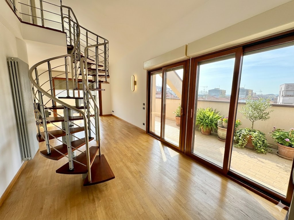 Ingresso dell'attico con scala di design e affaccio sulla terrazza
